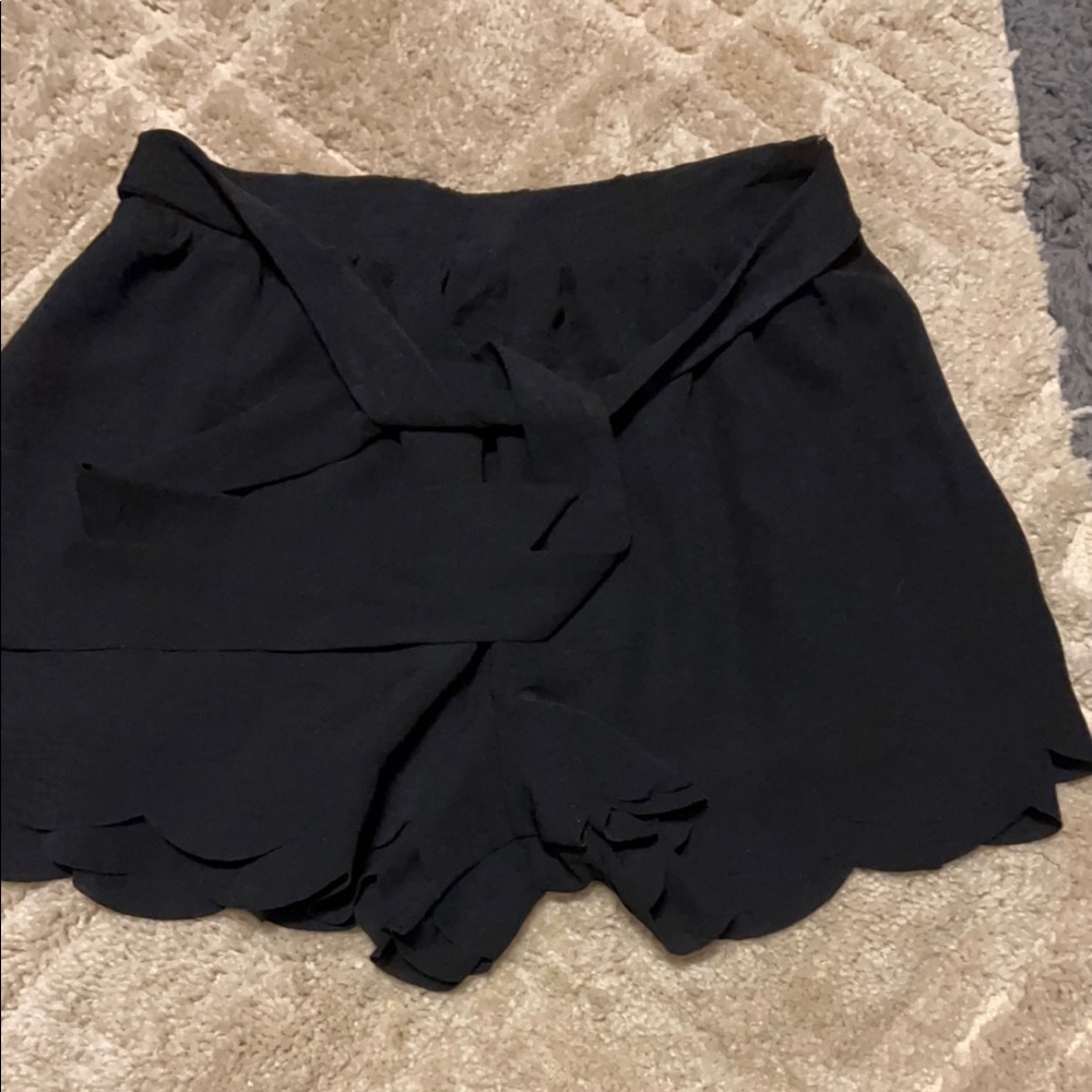 Black scalloped shorts.